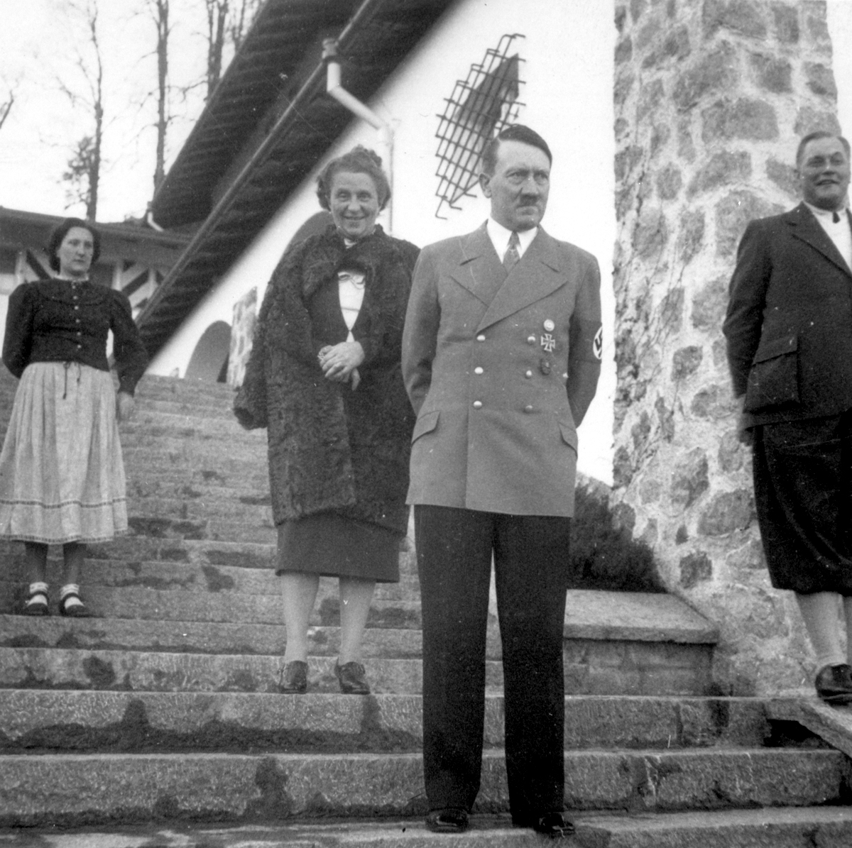 Adolf Hitler on the stairs of the Berghof before Franz Xaver Schwarz and his wife's visit for Scharz's birthday, from Eva Braun's albums
